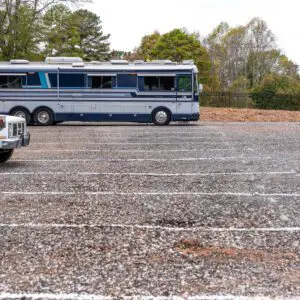 Empty parking lot with a parked bus.